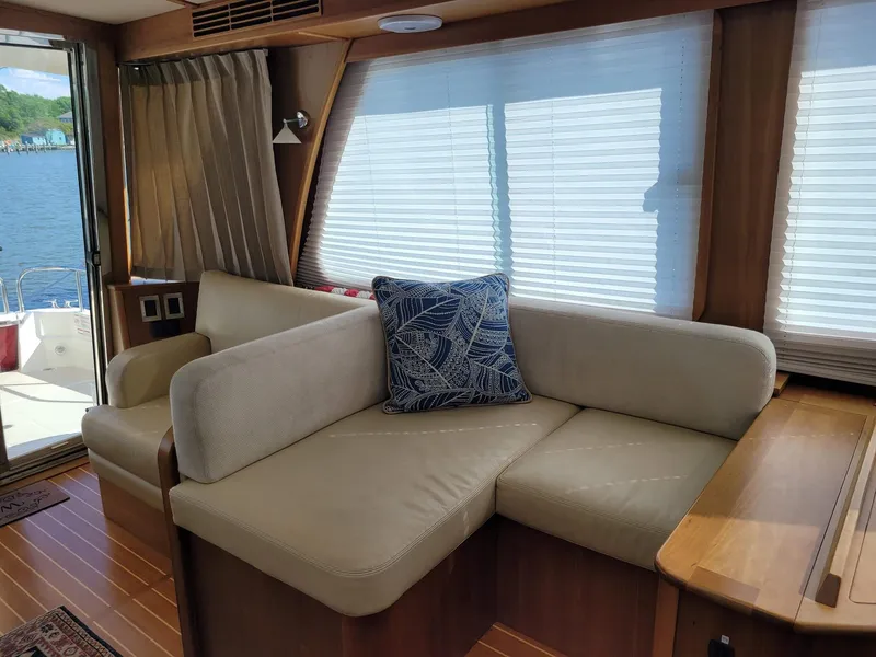 Slide: The Image of Interior of 2014 Sabre 48 Salon Express with beige sofa and nautical pillow. - 7