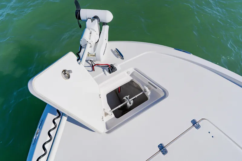 Slide: The Image of 2022 Caymas 28 HB boat deck with open storage compartment and trolling motor. - 11