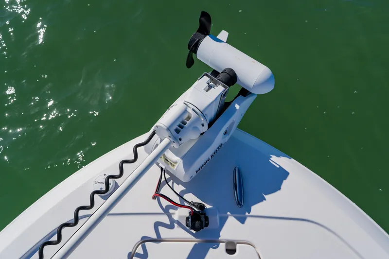 Slide: The Image of Bow of 2022 Caymas 28 HB boat with trolling motor on green water. - 12