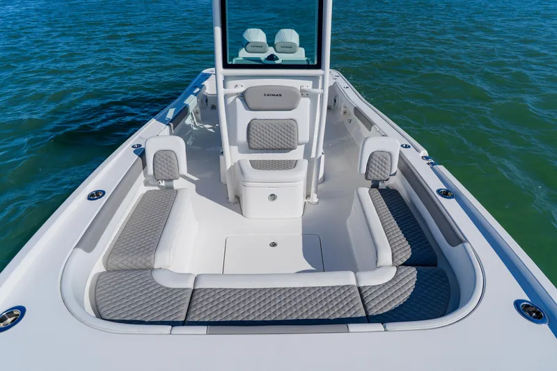 Slide: The Image of 2022 Caymas 28 HB boat interior with cushioned seating on calm water. - 15