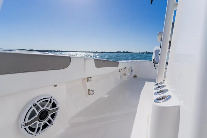 Slide: The Image of 2022 Caymas 28 HB boat interior with ocean view, featuring sleek design and speaker system. - 19