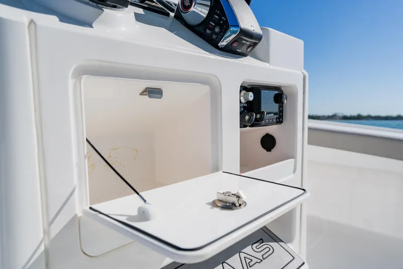 Slide: The Image of 2022 Caymas 28 HB boat console with storage compartments and control panel. - 26