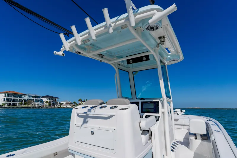 Slide: The Image of 2022 Caymas 28 HB boat on water, featuring modern helm and T-top design. - 29