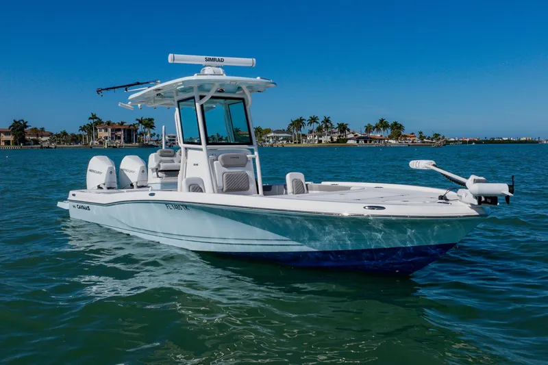 Slide: The Image of 2022 Caymas 28 HB boat on clear blue water with palm trees in the background. - 3