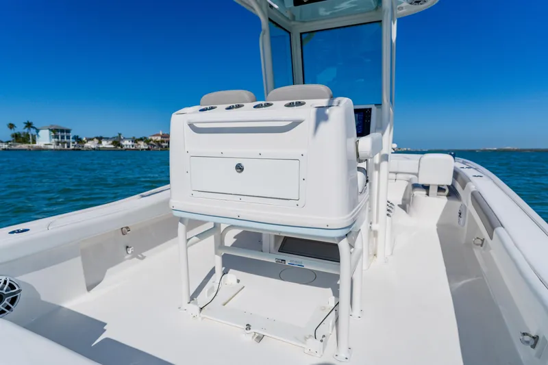 Slide: The Image of 2022 Caymas 28 HB boat interior with console, on calm blue water. - 30