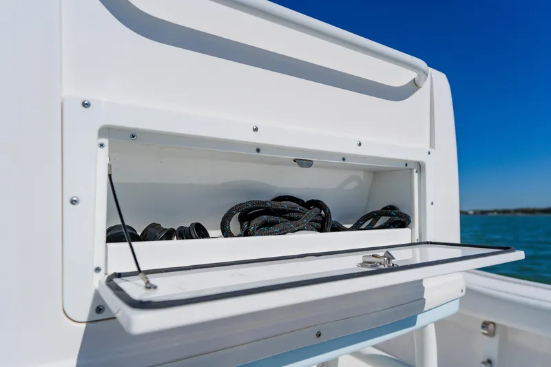Slide: The Image of Open storage compartment on 2022 Caymas 28 HB boat with coiled ropes inside. - 31