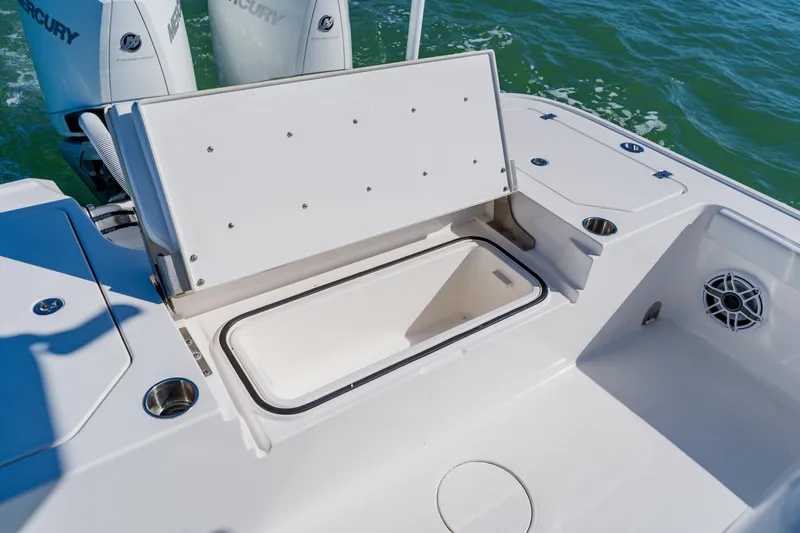 Slide: The Image of 2022 Caymas 28 HB boat with open storage compartment and Mercury engines. - 34