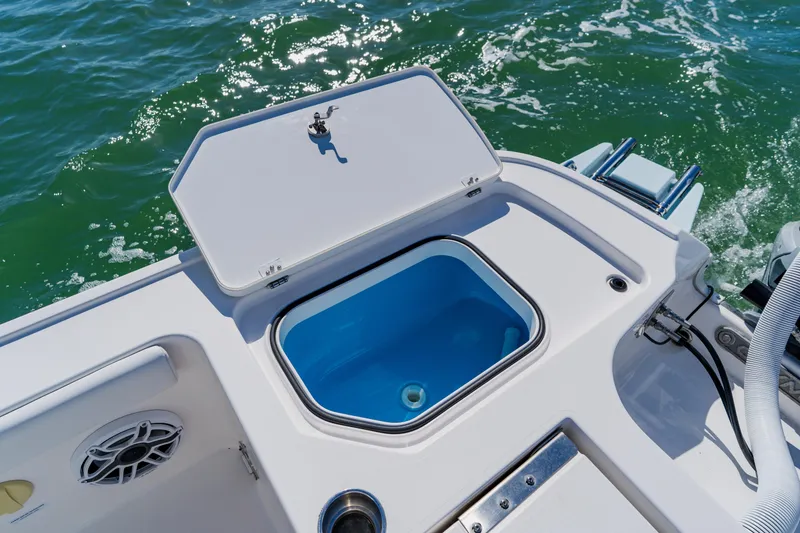 Slide: The Image of Open storage compartment on 2022 Caymas 28 HB boat, with ocean background. - 36