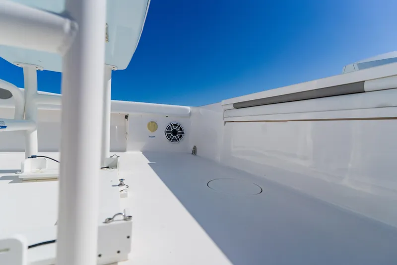 Slide: The Image of 2022 Caymas 28 HB boat deck with sleek white finish under clear blue sky. - 39