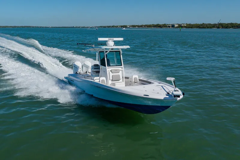 Slide: The Image of 2022 Caymas 28 HB boat cruising on open water, showcasing sleek design and performance. - 5