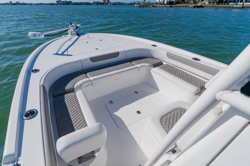 Slide: The Image of 2022 Caymas 28 HB boat interior with cushioned seating on calm water. - 8