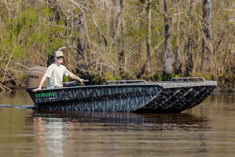 Slide: The Image of Man driving 2026 Havoc 1756 DBST boat with Yamaha motor on a calm river. - 11