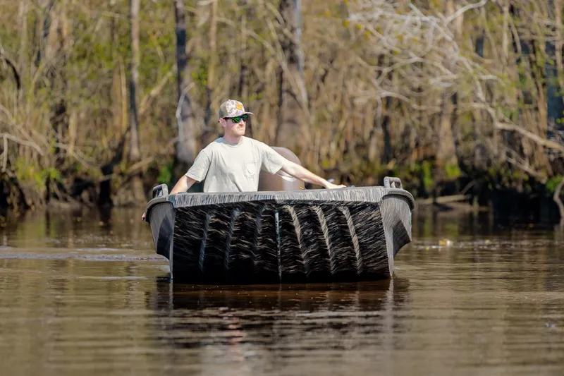 Slide: The Image of Man navigating a 2026 Havoc 1756 DBST boat on a calm river. - 12