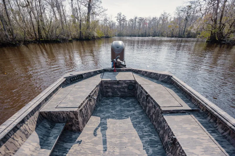 Slide: The Image of 2026 Havoc 1756 DBST boat on a calm river, surrounded by trees. - 15