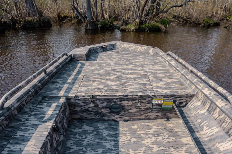 Slide: The Image of 2026 Havoc 1756 DBST boat with camouflage design on a calm river. - 16