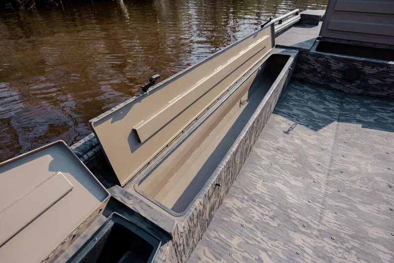 Slide: The Image of Open storage compartment on 2026 Havoc 1756 DBST boat, near water. - 21