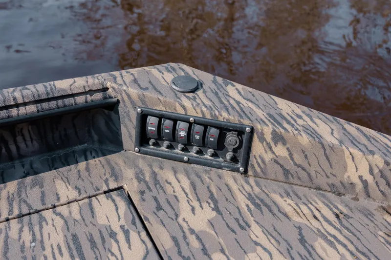 Slide: The Image of Control panel on 2026 Havoc 1756 DBST boat with camouflage design by the water. - 22