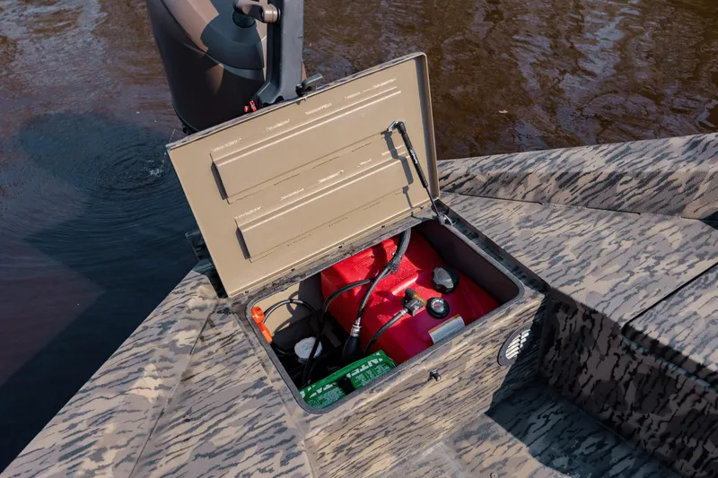 Slide: The Image of Open storage compartment on 2026 Havoc 1756 DBST boat, revealing fuel tank and battery. - 23