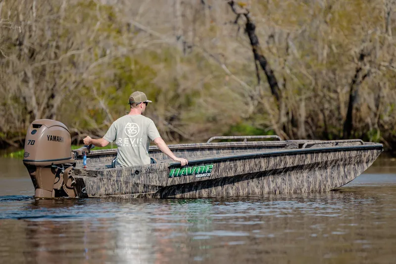 Slide: The Image of Man operating 2026 Havoc 1756 DBST boat with Yamaha motor on a calm river. - 7