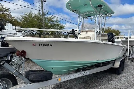The Image of 2020 Sea Chaser 23 LX boat on trailer, featuring a light blue hull and T-top. - 1