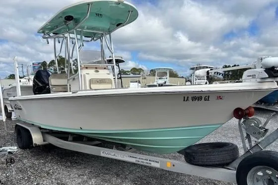Slide: The Image of 2020 Sea Chaser 23 LX boat on trailer, parked outdoors under cloudy sky. - 3