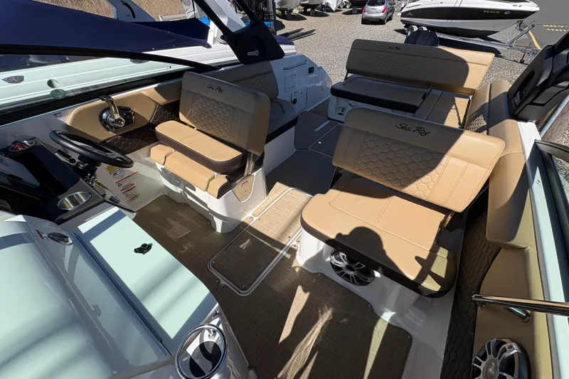 Slide: The Image of 2024 Sea Ray SDX 250 Outboard interior with tan seating and modern dashboard. - 10