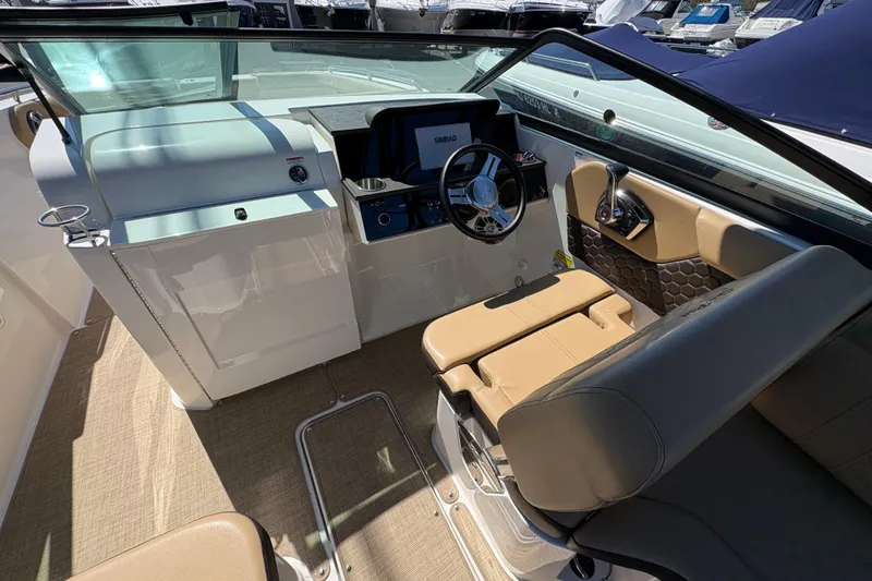 Slide: The Image of 2024 Sea Ray SDX 250 Outboard helm with modern controls and beige seating. - 13