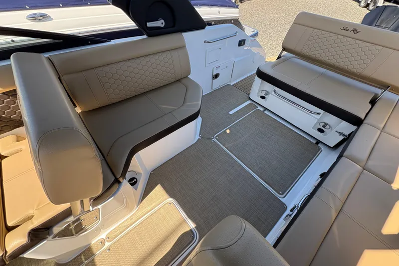 Slide: The Image of 2024 Sea Ray SDX 250 Outboard interior with beige seating and modern design. - 14