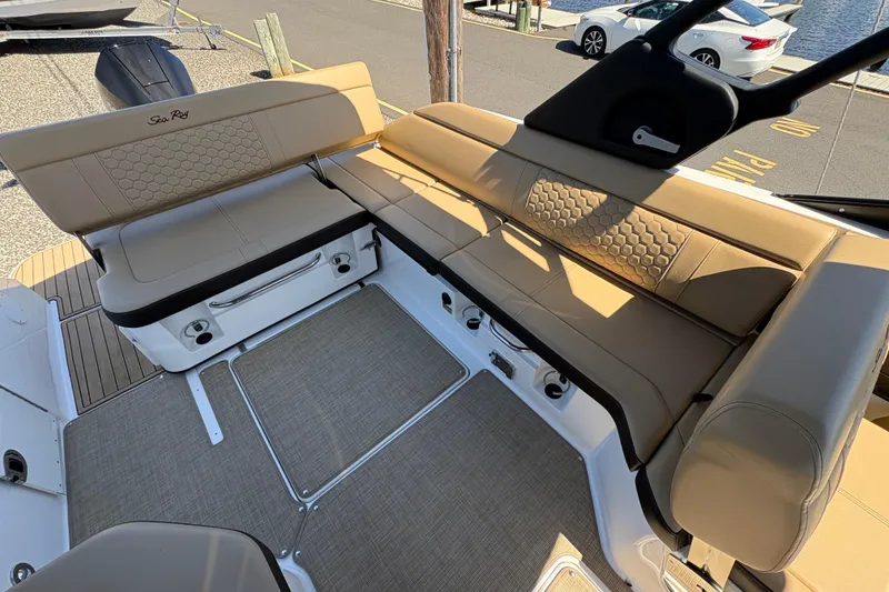 Slide: The Image of 2024 Sea Ray SDX 250 Outboard boat interior with tan seating and modern design. - 15