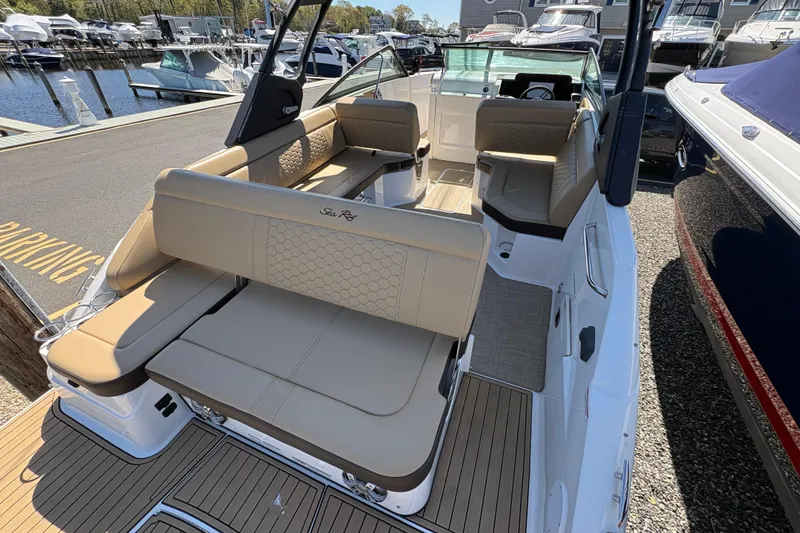 Slide: The Image of 2024 Sea Ray SDX 250 Outboard boat with luxurious seating at a marina. - 16