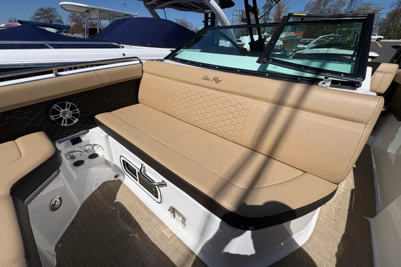 Slide: The Image of 2024 Sea Ray SDX 250 Outboard boat interior with tan seating and speaker system. - 8
