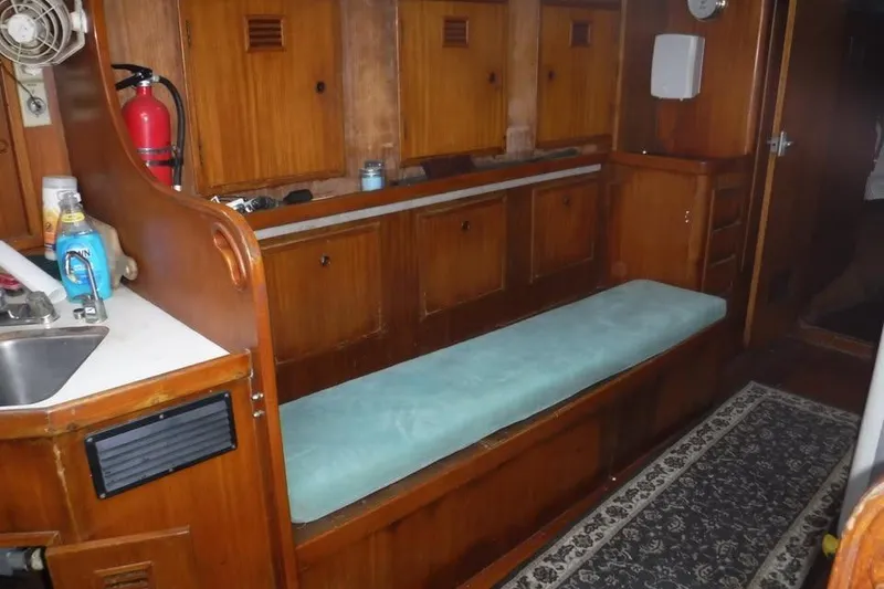 Slide: The Image of Interior of 1987 Cheoy Lee Pedrick 47 yacht with wooden cabinetry and cushioned seating. - 12