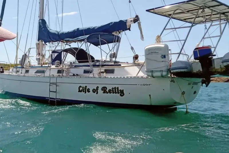 Slide: The Image of 1987 Cheoy Lee Pedrick 47 sailboat named "Life of Reilly" on turquoise water. - 18