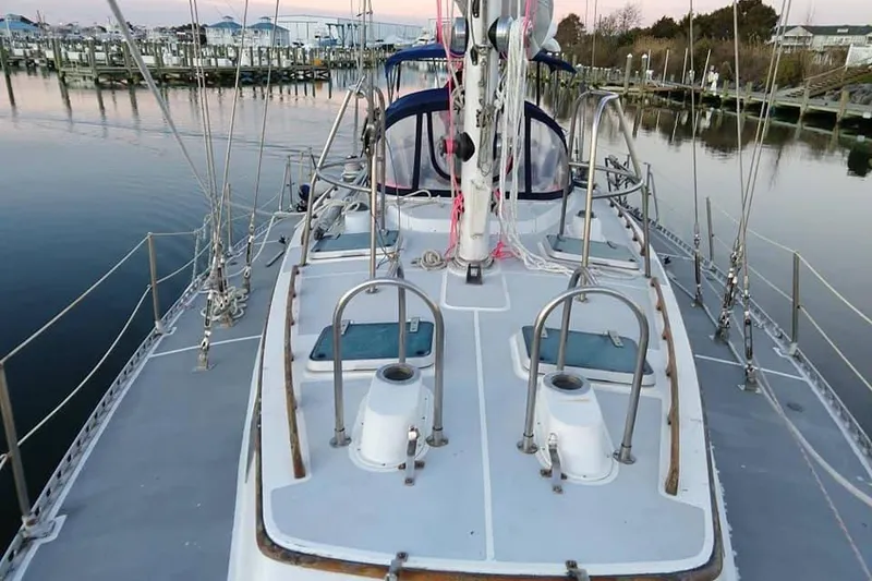 Slide: The Image of 1987 Cheoy Lee Pedrick 47 sailboat deck view at marina, showcasing rigging and hatches. - 2