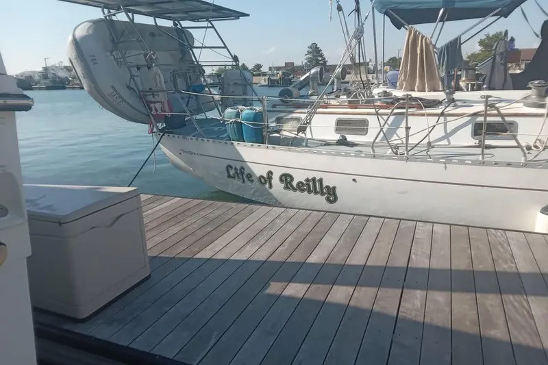 Slide: The Image of 1987 Cheoy Lee Pedrick 47 sailboat named "Life of Reilly" docked at a marina. - 4