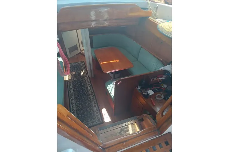 Slide: The Image of Interior of 1987 Cheoy Lee Pedrick 47 yacht with wooden table and seating area. - 5
