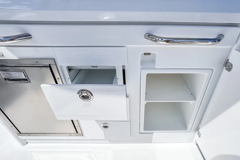 Slide: The Image of 2026 Wellcraft 28 T-Top boat storage compartments with stainless steel handles and sleek design. - 11