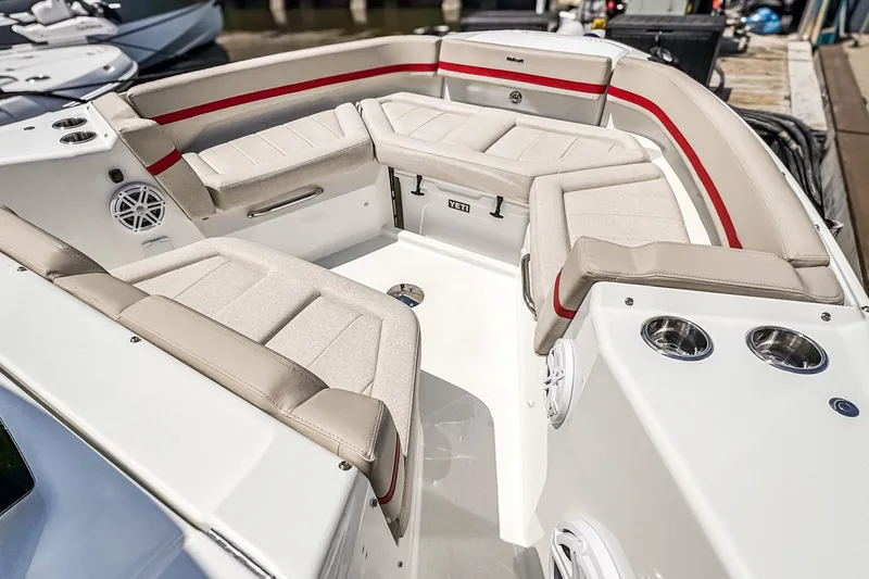 Slide: The Image of Luxurious seating area on 2026 Wellcraft 28 T-Top boat with beige cushions and red accents. - 3