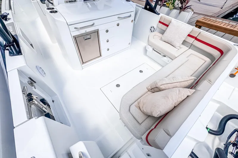 Slide: The Image of 2026 Wellcraft 28 T-Top boat interior with seating, storage, and modern amenities. - 7