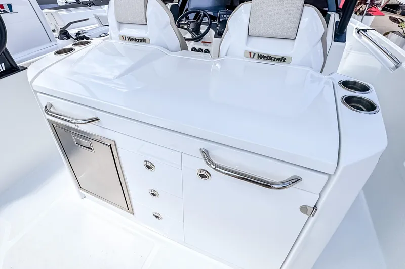 Slide: The Image of 2026 Wellcraft 28 T-Top boat interior with sleek white cabinetry and stainless steel accents. - 8