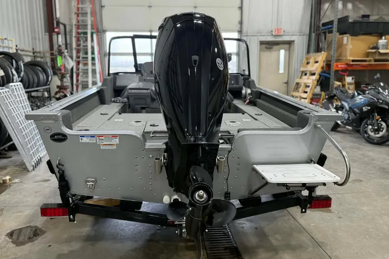 Slide: The Image of 2023 Starcraft Stealth 166 DC boat with outboard motor in a garage setting. - 4