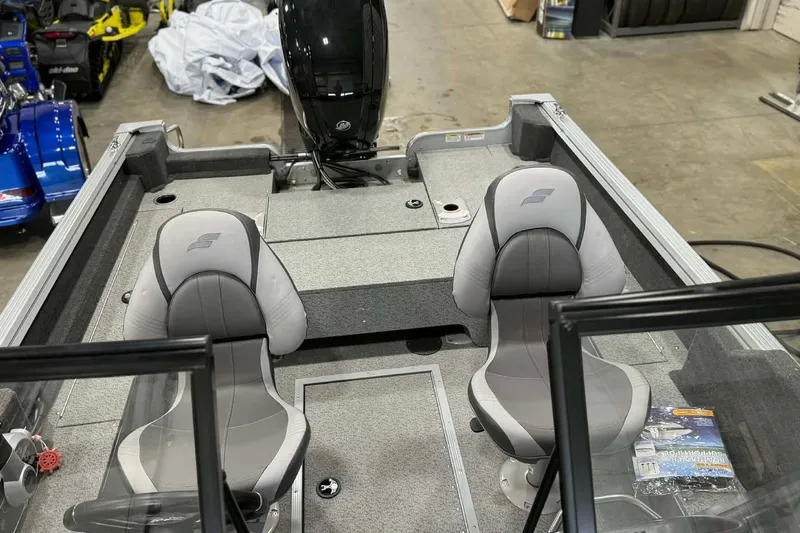 Slide: The Image of 2023 Starcraft Stealth 166 DC boat interior with two gray seats and motor. - 5