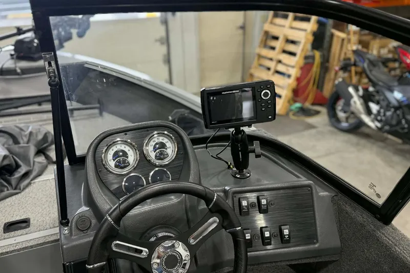 Slide: The Image of 2023 Starcraft Stealth 166 DC boat dashboard with steering wheel and electronic display. - 7