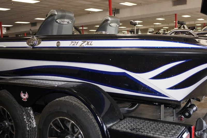 Slide: The Image of 2026 Phoenix 721 ZXL boat with sleek design and dual seats in showroom. - 11