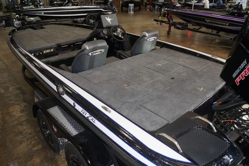 Slide: The Image of 2026 Phoenix 721 ZXL bass boat with spacious deck and dual seats in showroom. - 12
