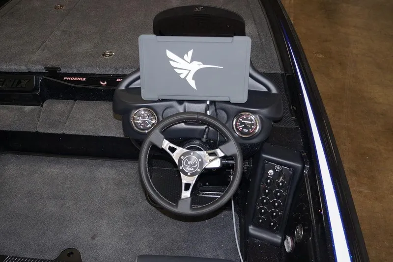 Slide: The Image of 2026 Phoenix 721 ZXL boat dashboard with steering wheel and control panel. - 26