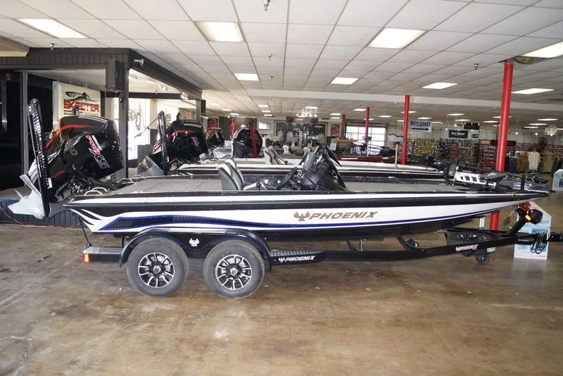Slide: The Image of 2026 Phoenix 721 ZXL bass boat displayed indoors on a trailer. - 3