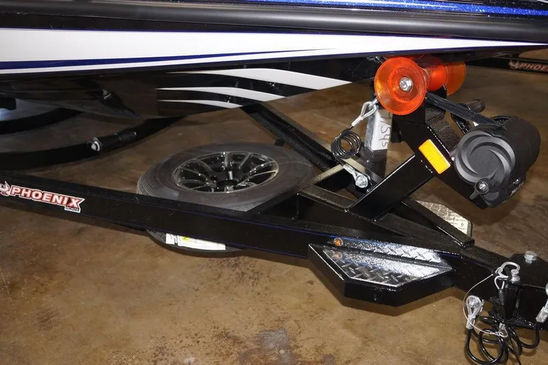 Slide: The Image of Trailer hitch of 2026 Phoenix 721 ZXL boat with black frame and orange rollers. - 5