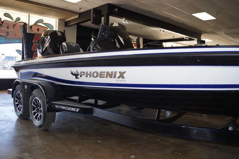 Slide: The Image of 2026 Phoenix 721 ZXL boat on display in showroom, featuring sleek design and dual motors. - 8
