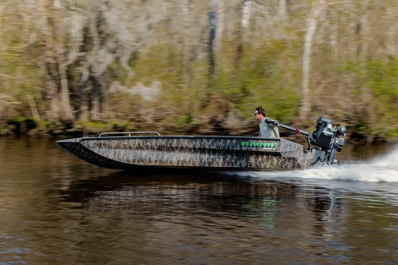 The Image of 2026 Havoc 1756 MSTC boat speeding on a river with blurred forest background. - 0